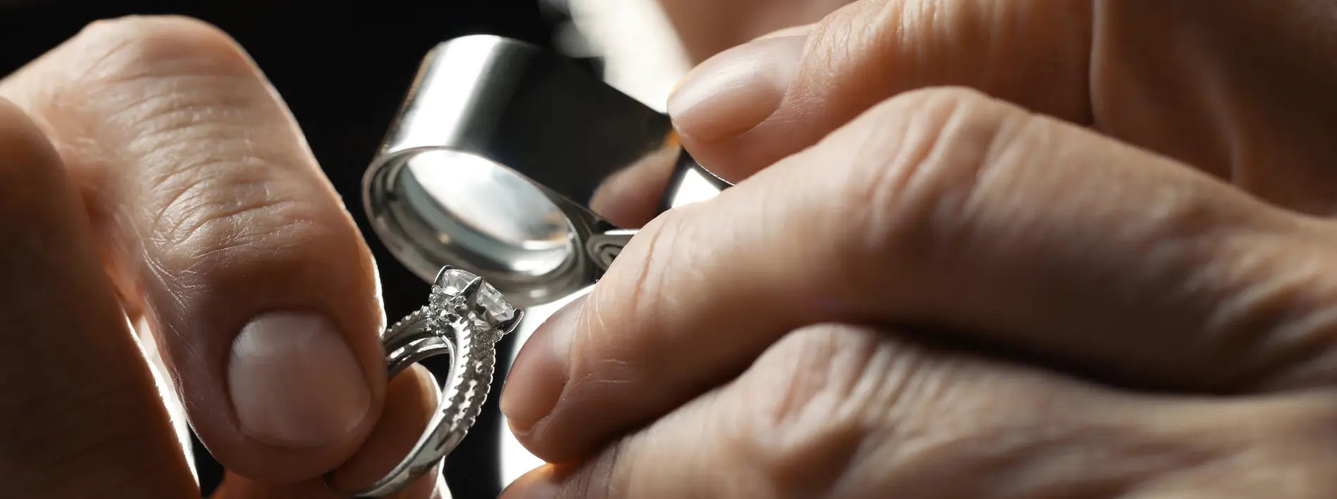 Jeweller inspecting silver ring for valuation