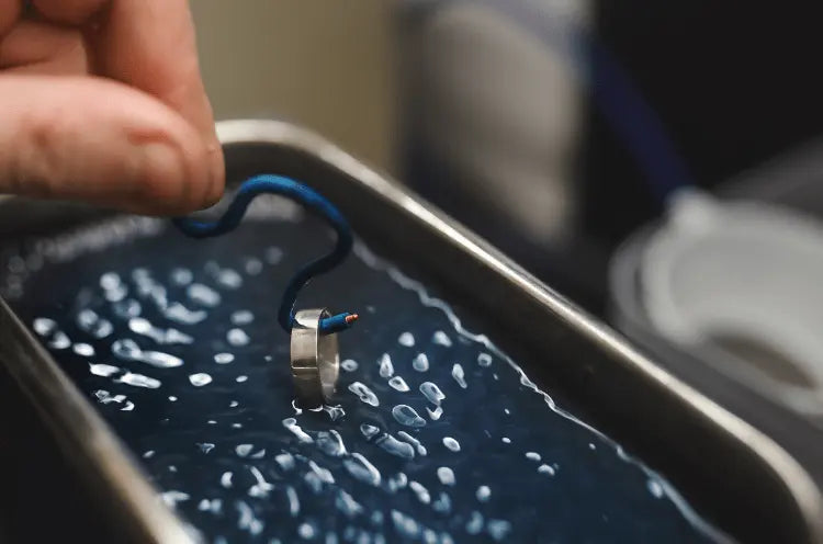 Person cleaning a silver ring with ultrasonic cleaner